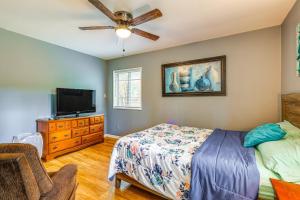 a bedroom with a bed and a flat screen tv at Pet-Friendly Decatur House Near Huntsville! in Decatur