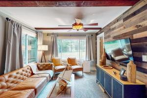 a living room with a couch and a flat screen tv at Afterglow in Glenn