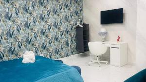 a bedroom with a blue bed and a wall mural at La Vecchia Rosa in Catania
