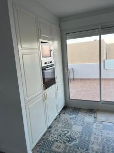 a room with a kitchen with a sliding glass door at Casa Susana in La Azohía