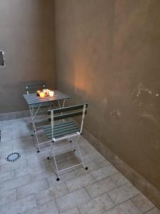 a table with a bench and a table with candles on it at Napoli the charme in Naples +45 photos