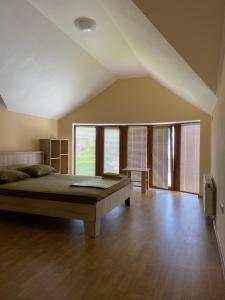 a large bedroom with a large bed and wooden floors at Veranda Guest House in Chornomorsk