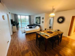 a living room with a table and a couch at Miami Hollywood Great 2 Bedroom 2 Bathroom with Intercostal View 001-22bvic in Hollywood