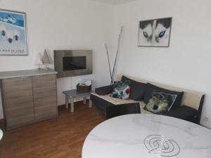 a living room with a couch and a table at Appartement "ENTOURLOUP" classé 2 étoiles in Le Dévoluy