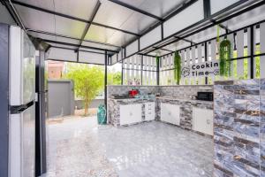 a kitchen in a building with a lot of windows at The Moment Pool Villa Bangsaray in Bang Sare