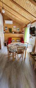 a dining room with a table and chairs in a room at Chalet calme in Saint-Léger-les-Mélèzes