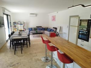 a kitchen and living room with a table and chairs at Mas en Provence in Le Thor