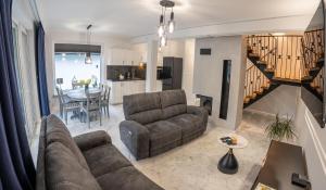 a living room with a couch and a dining room at Bieszczadzka Wataha in Paszowa