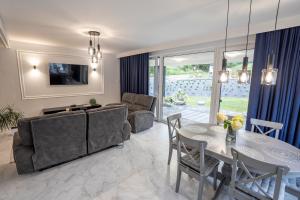 a living room with a couch and a table at Bieszczadzka Wataha in Paszowa