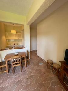 a dining room with a table and a kitchen at Palio Limani Studio in Spetses +17 photos