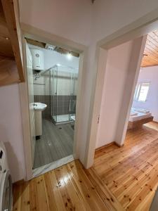 a bathroom with a glass shower in a room at Central Apartment Gjirokaster in Gjirokastër