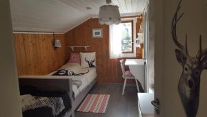 a bedroom with a bed in a small room at Chalet Chic mit Hot Pot in Wildhaus +18 photos