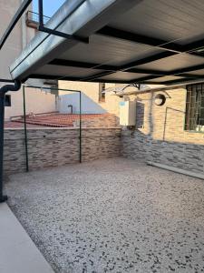 an empty parking lot in a building with a brick wall at Moonlight B&B in Canosa di Puglia