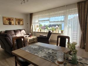 a living room with a table and a couch at Ferienwohnung Danny in Bad Sachsa