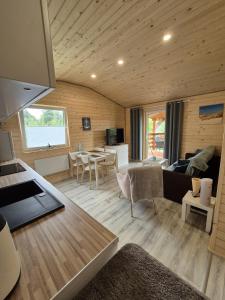 a living room with a couch and a table at Domus Mare Tiny House 2 in Wisełka