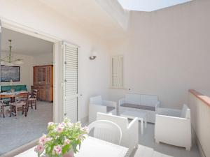 a living room with white furniture and a table at [Baia di Guidaloca] Villino Scopello Free Parking in Scopello +9 photos