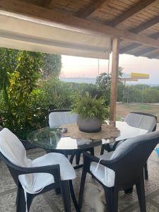 a table with chairs and a potted plant on a patio at COTTAGE villa in Káto Panayía