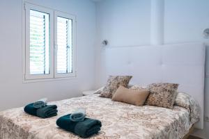 a bedroom with a bed with towels on it at Bellavista in Tías