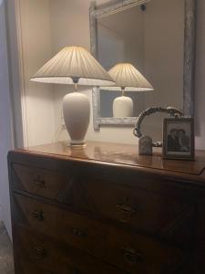 a dresser with a lamp and a mirror on it at COTTAGE villa in Káto Panayía +59 photos
