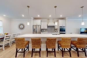 a kitchen with a large white table and chairs at Sea Oaks Village 4 in Berlin
