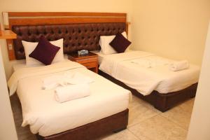 Postel nebo postele na pokoji v ubytování js hotel suites