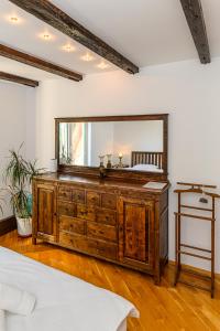 a bedroom with a large mirror on top of a dresser at Pensiunea Casa Bono in Braşov +121 photos