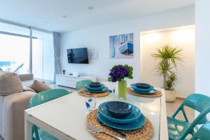a living room with a table with blue dishes on it at Bellavista in Tías