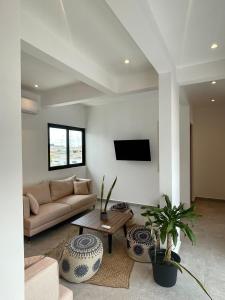 un salon avec un canapé et une télévision dans l'établissement DOI 45 Apartment, à Playa del Carmen