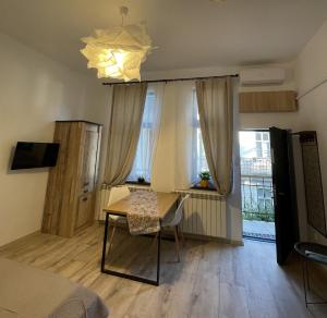 a bedroom with a desk and a bed and a window at Next Door Studio in Cluj-Napoca