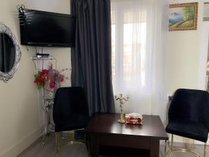 a living room with a cross on a table and a tv at Отдых в Ташире in Vorontsovka