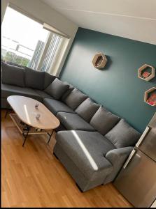 a living room with a couch and a table at Sentral leilighet til utleie in Stavanger