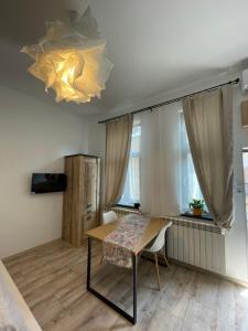 a dining room with a table and a chair at Next Door Studio in Cluj-Napoca