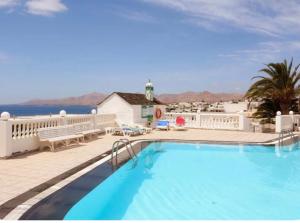 a swimming pool with a view of the ocean at Bellavista in Tías