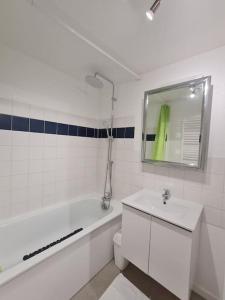 a bathroom with a tub and a toilet and a sink at Le BEAU SEJOUR in Poitiers +24 photos
