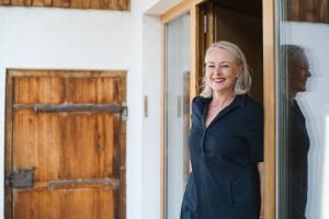 a woman standing in front of a door at Appartements Christine in Bezau