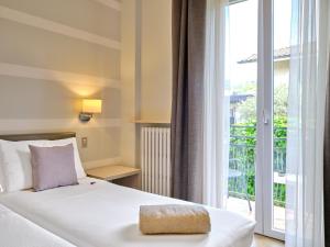 Postel nebo postele na pokoji v ubytování Hotel Eden Garda + 37 fotografií