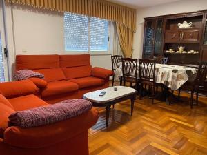 a living room with a couch and a table at Ático Calvo Sotelo 217 in Sarria