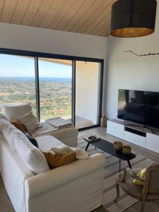 a living room with a white couch and a large window at Villa skyline in Toulon