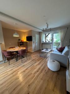 a living room with a couch and a table at Apartment zum Aatal in Bad Wünnenberg