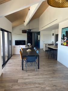 a dining room and living room with a table and chairs at Villa skyline in Toulon