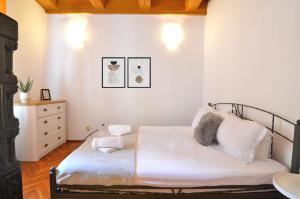 a bedroom with a bed with white sheets and pillows at Charming Apartment - Heart of Brașov Poarta Schei in Braşov