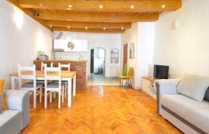 a kitchen and living room with a table and chairs at Charming Apartment - Heart of Brașov Poarta Schei in Braşov