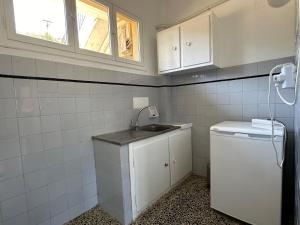 a small kitchen with a sink and a window at Bouros Seaview Farm in Karistos