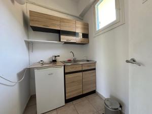 a small kitchen with a sink and wooden cabinets at Bouros Seaview Farm in Karistos
