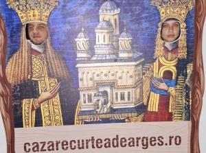 a mural of two priests with a sign that reads cathedral challenges at Victoriei 35B in Curtea de Argeş +1 photo