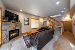 ein Wohnzimmer mit Couch und Kamin in der Unterkunft Sierra Pines Villa Deck Jetted Tub Game Rm in Shaver Lake