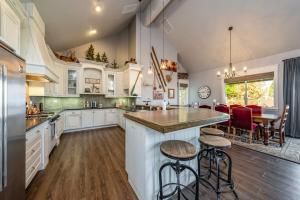 a large kitchen with white cabinets and a large island at The Great Escape Sunsets Hot Tub Bliss in Shaver Lake