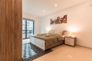 a bedroom with a bed and a large window at Spacious - Beautiful - Sea Front in Sliema