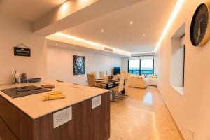 a kitchen and living room with a clock on the wall at Spacious - Beautiful - Sea Front in Sliema