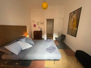 a bedroom with a large bed and a chair at Design House Monti in Rome